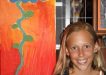 Emma Worthington with her floral art at Brushes by the Sea, the annual art show in Rainbow Beach