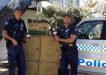 Local officers Mike Brantz and Mick Emery get ready to distribute the anti-domestic voilence coffee cups