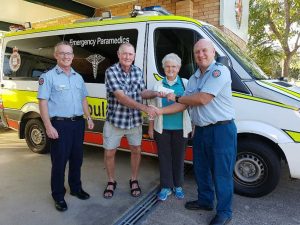 Assistant Commissioner Michael Metcalf and Officer in Charge Wilbur Fahey accepting the $500 donation from representatives of the Sleepy Lagoon Hotel Sports and Social Club.