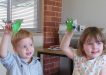 Fletcher and Scarlett hold up their recycled craft at Tin Can Bay Library