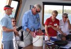 Tin Can Bay waterwatchers, Alan Jones with Bill and Jenny Adamson enjoy the end of year cruise