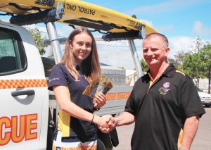 Summer Surf Girl, Elizna Smit, receives a very generous donation from PFD Foods, presented by Surf Club Supporters Club President, Mr John Greaney  Image Barb Rees