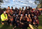 23-year-old Shane Berkhout won a bronze medal at the Australian Dragon Boating Championships, behind him is the Queensland Premier Men and Women’s Relay Teams