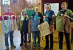 Quilting ladies with the bags they made for the nursing home