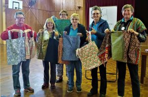 Quilting ladies with the bags they made for the nursing home