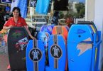 Deb O’Donnell shows off the body boards at 7th Wave Epic Ocean Adventures is also a great spot for shopping and Ola Gunzel will help you find a present - perhaps a surfboard?