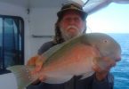 Fishing Club member Ron Cox with a parrot