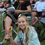 Indianna Sinclair enjoys a sausage while Nana Laurelle Levy waits for the carols to start - Image Jess Milne