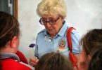 Keeping The Legacy Alive: Melissa Haslam's photo of Pam Leslie, awarded Life Membership of the RSL QLD Branch was taken with Pam surrounded by the school children at one of her many school visits. Not much taller than the children, Pam is explaining the history of the poppy in preparation for Anzac day last year.