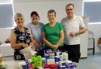 QCWA Member Joan, Debbie, Dawn and Mark with some of the Care Pack items