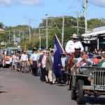 A large crowd waved flags as the Anzac Day March progressed through the main street