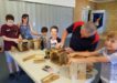 Busy little bees enjoy making planter boxes with Paul Vick