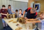 Busy little bees enjoy making planter boxes with Paul Vick