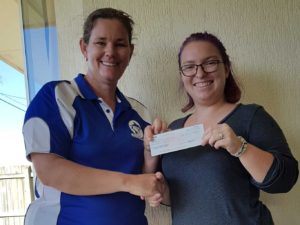 Cooloola Coast Little Athletics Centre Manager, Jess Milne recieves the donation from Chamber of Commerce President Bianca Hayward