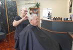 Barber Chris Challenor gives Trevor Booth a trendy trim