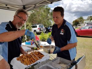 Tin Can Bay Fishing Club members, Harry Duncan and Paul Morehouse, cook up a feast of fish Image Jess Milne