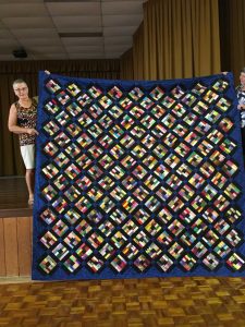 Angie Wiese with a quilt made from her stash of fabrics