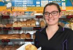 Cleressa Clark of Rainbow Beach holds the famous corn beef and white sauce pie from Ed’s Beach Bakery at Rainbow Beach - listed as No. 1 for Top Ten Pies around Australia, by Creek to Coast