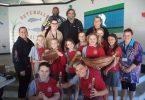 NAIDOC Day Photo Attached – Community Elders with some of the students learning about the bush tucker and artifacts.
