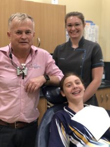 Emily-Jane Davey very excited to be finished orthodontic treatment and have her bands taken off - here with Dr Mark and Dental Assistant Chloe Williams