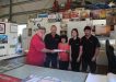 Kim and the crew from Bay Auto at Cooloola Cove presenting Bryan Phillips (Shed Manager) with a cheque for bench sponsorship