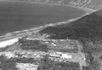 An aerial photo of Rainbow Beach from 1965 showing the Mineral Sands Building, the three mining houses, the Surf Club, Phil Rogers’ shop and a few caravans (supplied Garry Hewitt)