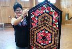 Leonie from the Tin Can Bay Quilting Club with her dazzling table runner