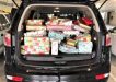 The back of the Manager Brad Robb’s car packed full of presents on their way to Community Action