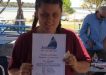 Ella Beauchamp with her Certificate of Achievement from Sailability at Tin Can Bay