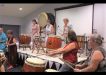 The Japanese Drumming Group with QCWA members, Lorraine and Irene, trying out the drums!