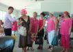 Maree Van Oirshot in the pink wig, with Auctioneer Andrew Hawkins with the Pink Ladies of Rainbow Beach at one of Maree’s Breast Cancer Awareness events