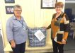 QCWA Tin Can Bay president, Wendy presenting donation to Julia from the Gympie/South Burnett Division President