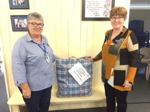 QCWA Tin Can Bay president, Wendy presenting donation to Julia from the Gympie/South Burnett Division President