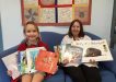 Amanda Geurts and librarian Mrs Sue Dan with some of the books donated by the Geurts family the to Tin Can Bay school library