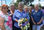 Members of the Tin Can Bay QCWA, Linda, Jill, Wendy, Robyn, Brenda and Dawn with the wreath they presented on Remembrance Day