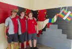 Year 9 students Rakeen, Blake and Mark, who are helping to complete the artwork at the Multi Purpose Space at Tin Can Bay school