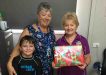 Santa’s helper, Steven, Wendy from the CWA and Eileen at the Resource Centre accepting presents