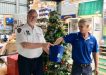 Commander John Macfarlane and Mark from Mitre 10 drawing the Christmas raffle winners for the Tin Can Bay Coastguard