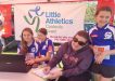 Little Athletics - Renee Burton filling in registrations at the sign-on day at the Tin Can Bay Markets