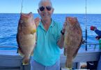 Fishing Club President Jim George with two nice maori cod caught a few kilometres off Rainbow Beach