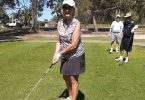 Jenny Skuja teeing off, with Barry Hudson and Lindsay Cullen watching