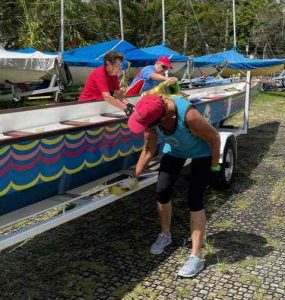 Cleaning the brightly coloured boats after being out on the water