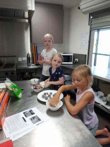 Taya, Xaiya, and Hazel making protein balls during one of our cooking sessions