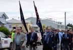 Tin Can Bay RSL President Don Holland leads the march
