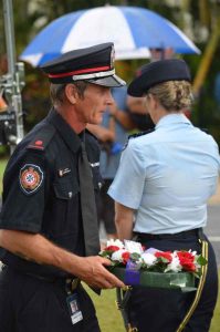 Darren from the Tin Can Bay auxiliary fire station lays a wreath