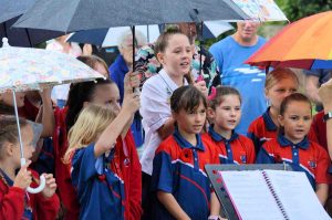 The Tin Can Bay school choir bravely battled the rain and performed beautifully