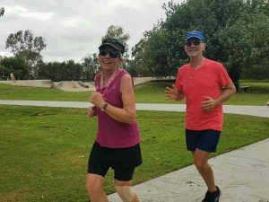 Cr Dan Stewart and his wife Sue run through the finish line