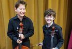 Cheeky young talents Bailey and Callum ready to rock at the recent Cooloola Community Orchestra concert