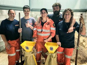 The Rainbow Beach SES crew give a thumbs up for the donation of the stands