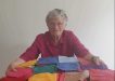Member Rowena’s mother Peggy with some of her many knitted squares